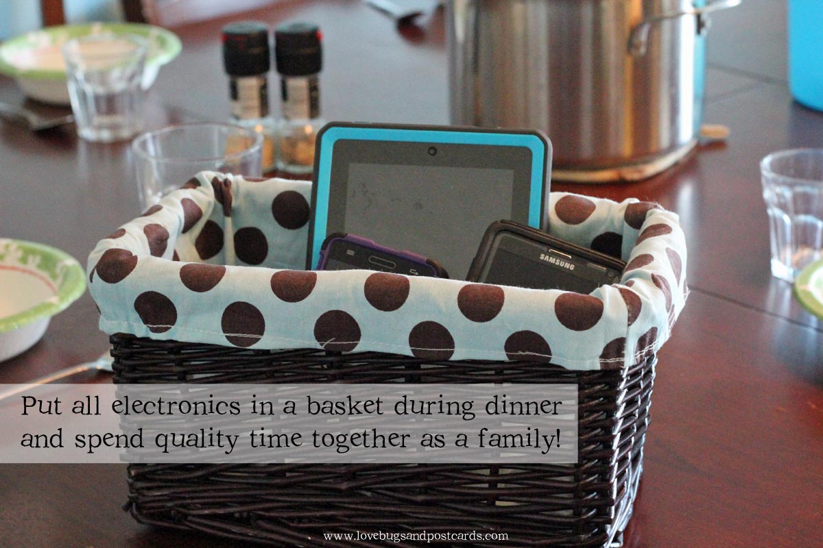 Basket for phones on table during dinner