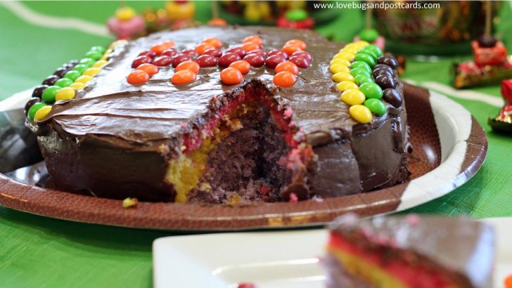 Rainbow football cake made with Skittles for Super Bowl fun #MakeSB50Sweeter