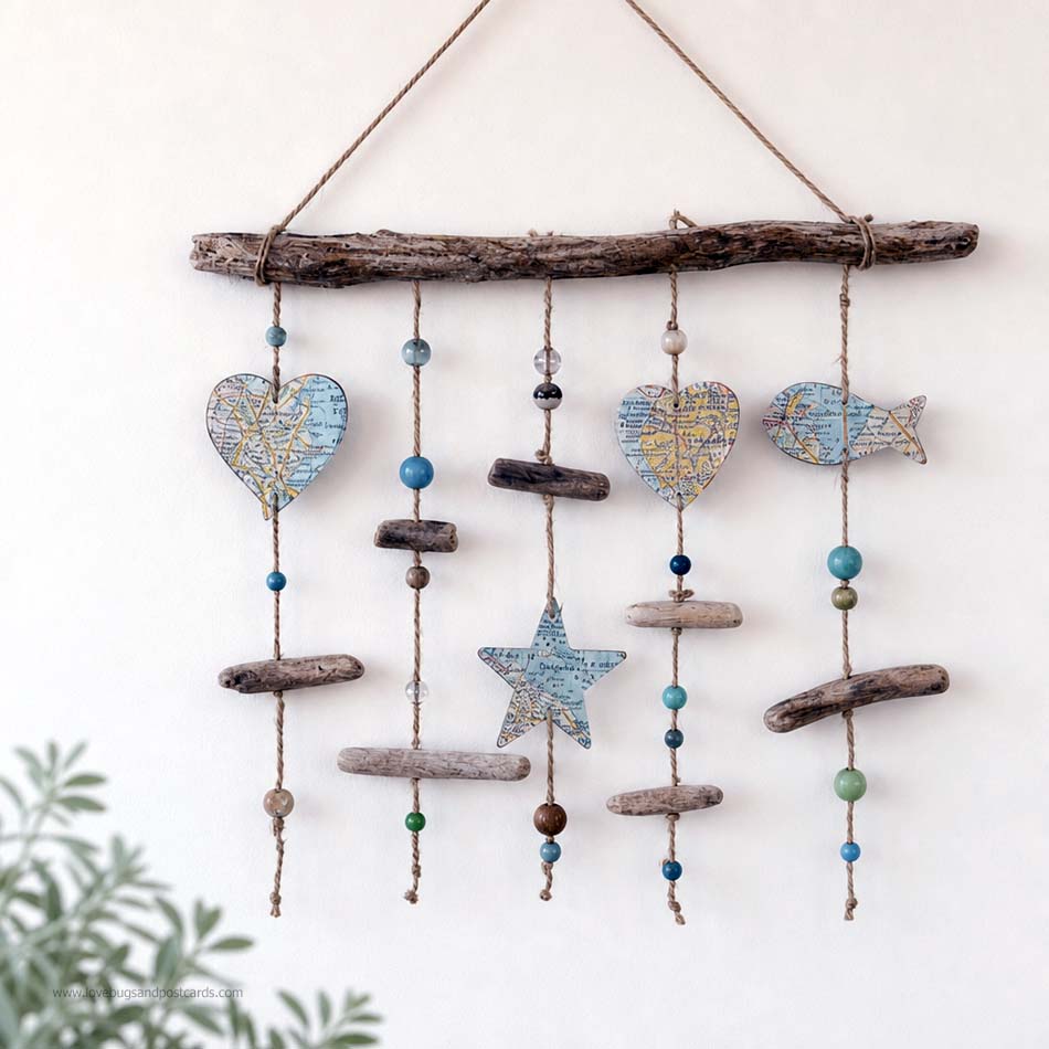 Rustic driftwood wall decor with beads and paper shapes.